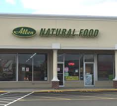 beige building with unlit Allen's Natural Food sign.